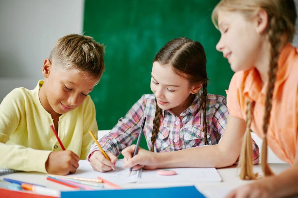 Kids writing on papers with their pencils