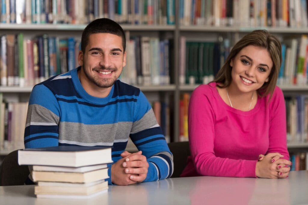 A man and a woman sitting in a library