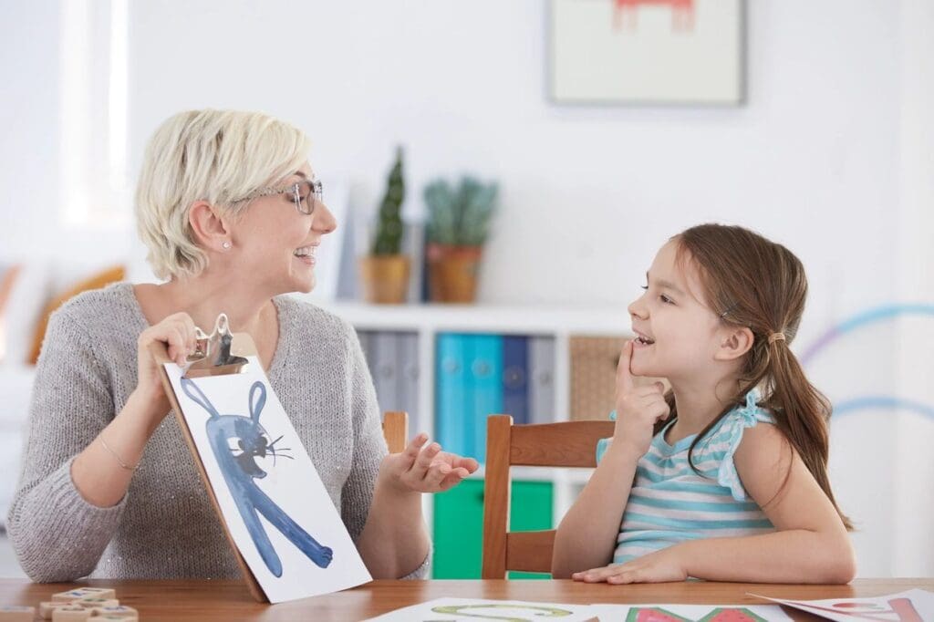 A woman showing a painting to a kid